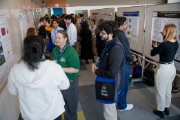 Conference attendees at SURC 2026 mill around looking at presentations on boards