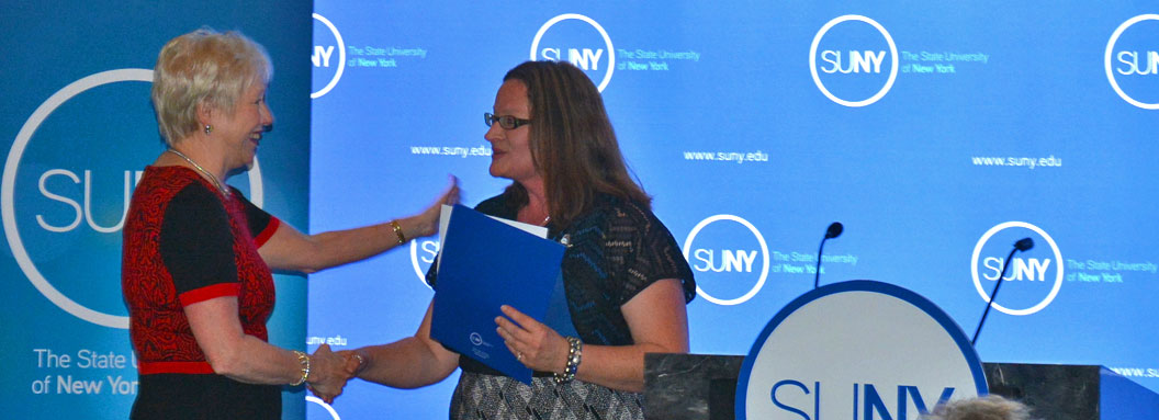 Lori Mould, the 2014-15 Student Assembly President shakes hands with Chancellor Zimpher at her swearing in ceremony.