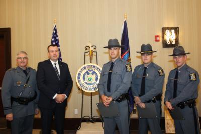 Members of the University Police stand in front of flags at the 2015 Chiefs Association awards.